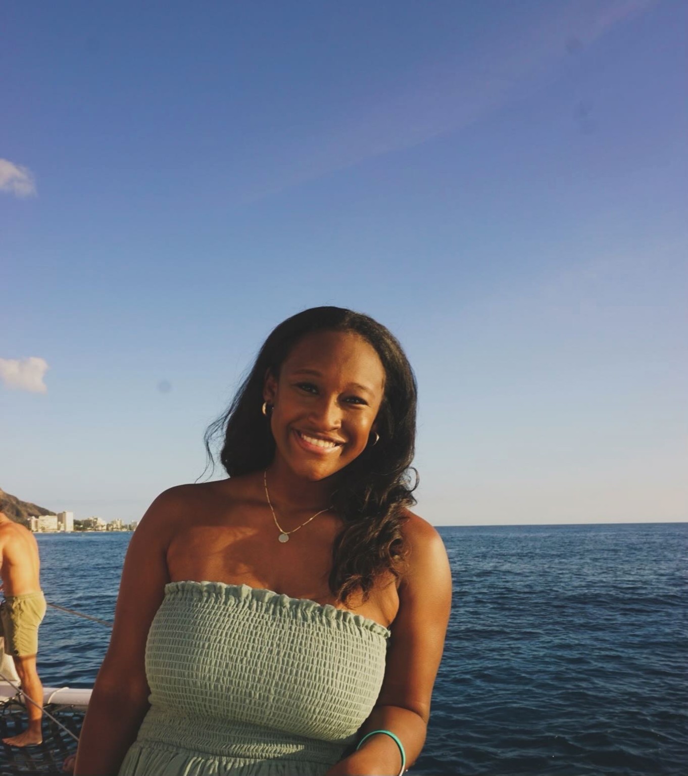 Alex smiling by the water